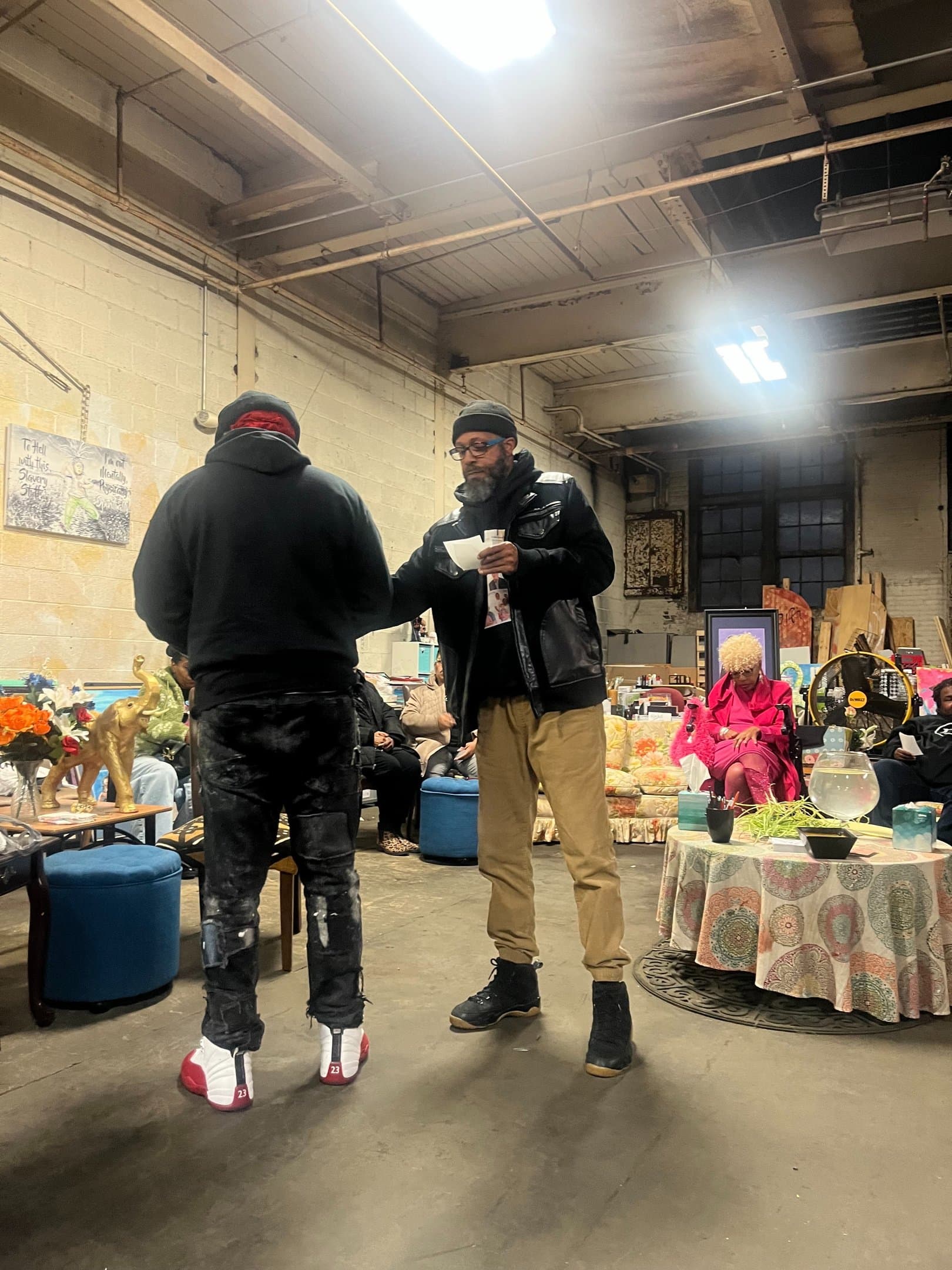 Wesley Robinson receiving written reflections from a Poetry Clinic participant