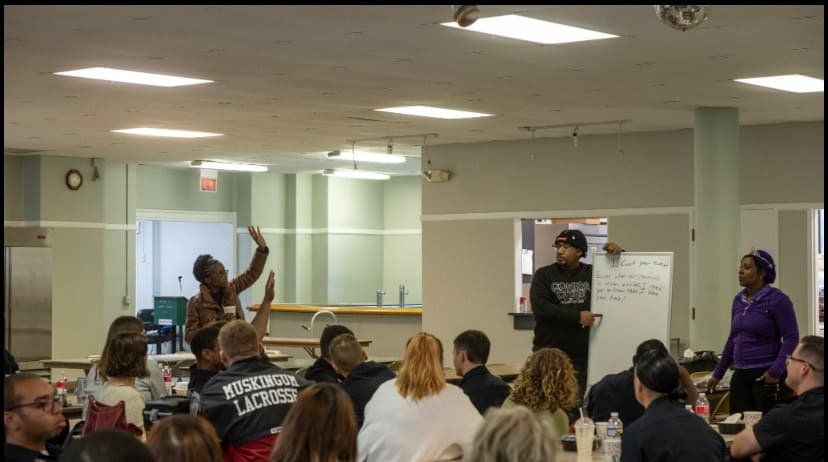 A Poetry Clinic participant contributing while Wesley holds the group writing